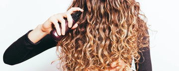 Woman styling her curls