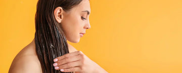 Woman using hair oil as her hair mask