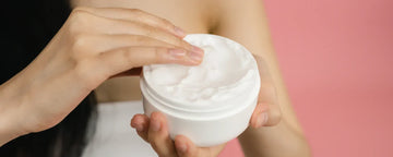 Woman applying hair conditioner onto her hand