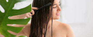 woman brushes her wet hair