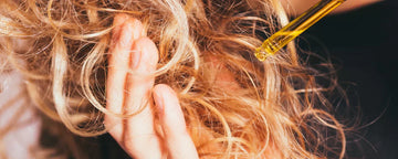 Woman using hair oil in her hair ends