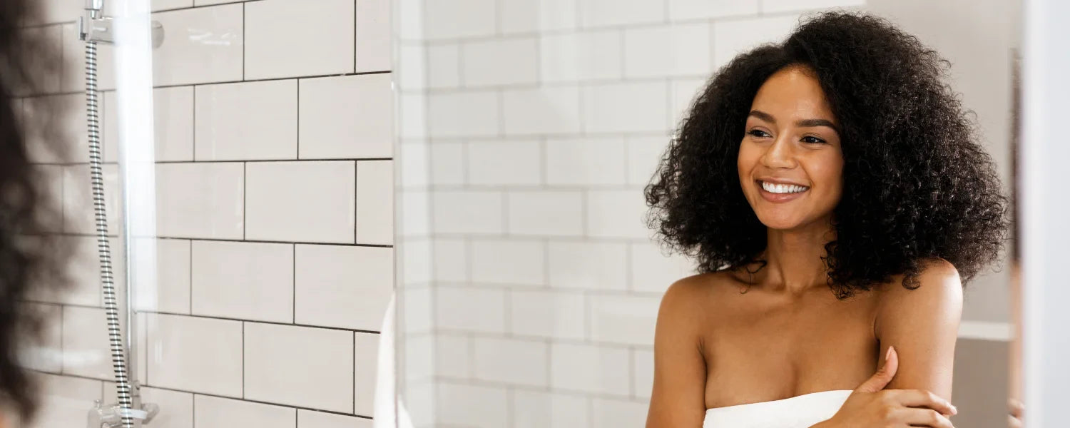 Woman with curls looking in the mirror