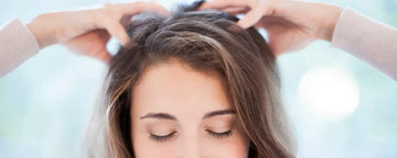 woman rubbing her scalp