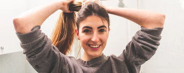 Woman makes ponytail