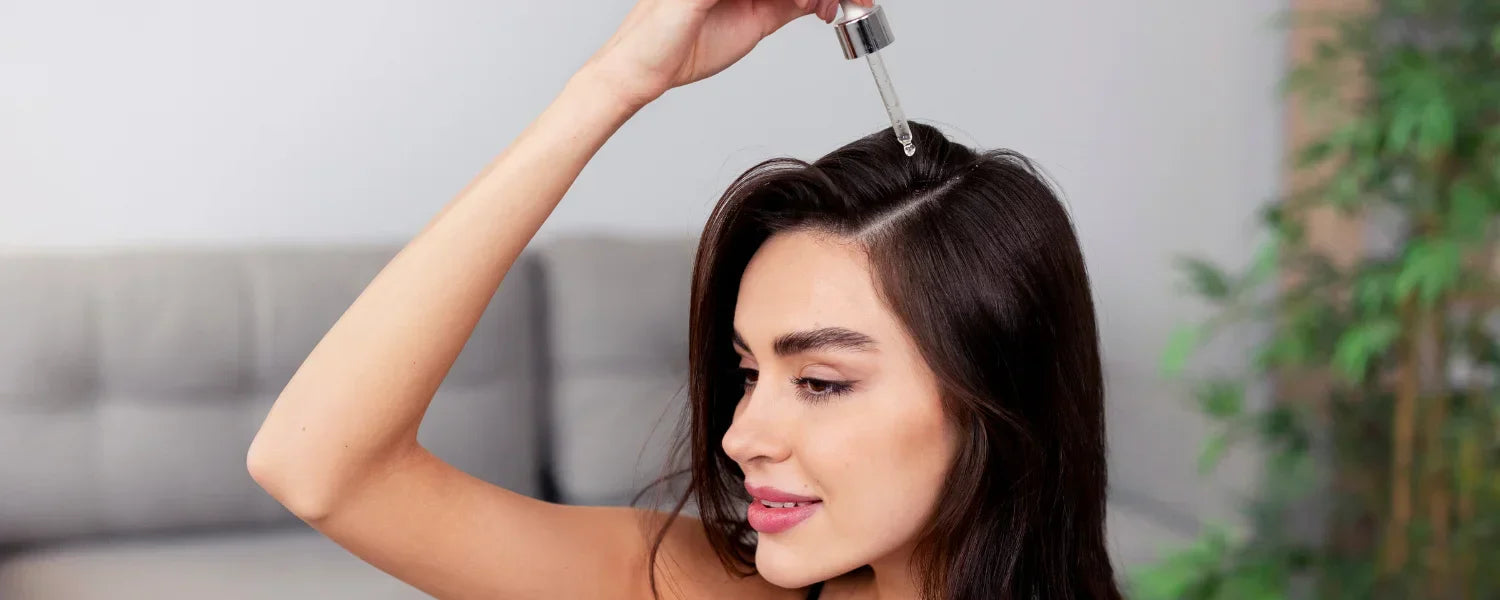Woman applying serum to her hair