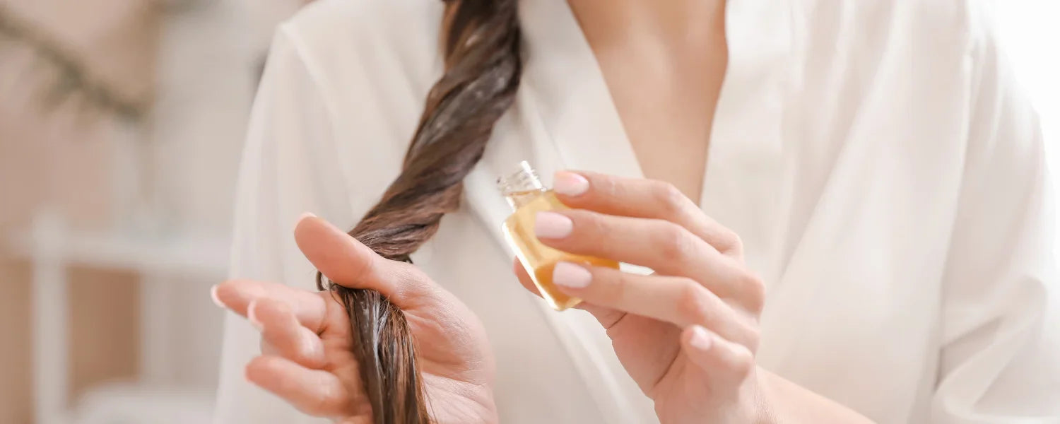 Woman applying hair oil in wet hair
