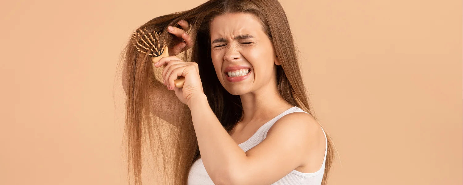 woman brushing tangled hair