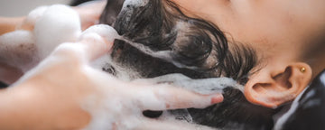 Woman uses shampoo for colored hair